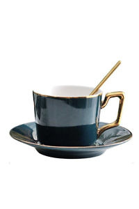 dark green porcelain coffee cup with saucer and two gold colored spoons